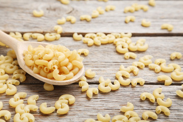Pasta penne on the grey wooden table