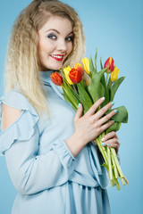 Woman holding bouquet of tulips flowers