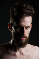 man, bearded young hipster has mustache on serious face