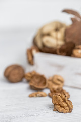 different nuts closeup on white wooden background