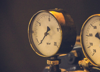 Pressure gage manometer,measuring water pressure pipe and valves on the background.