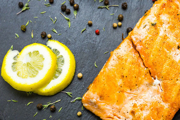 Grilled salmon steak with fresh lemon top view