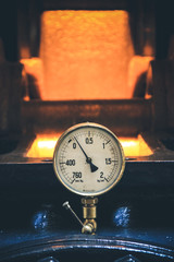Pressure gage manometer,measuring water pressure pipe and valves on the background.