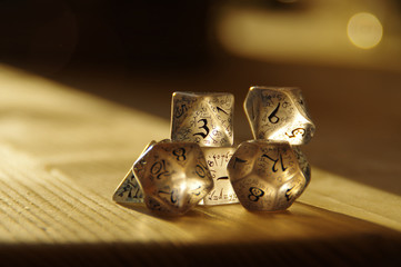 Few transparent rpg dice on table highlighted by the sun. D&D - Dungeons and dragons.