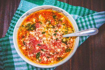 Traditional Ukrainian Russian vegetable borscht on the white wooden background. Top view