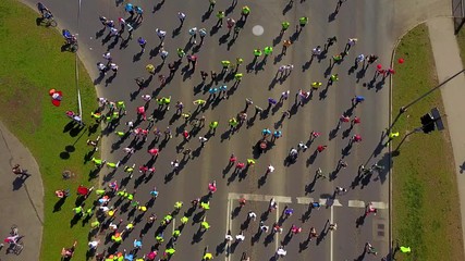 Aerial view of the people running the marathon down the city streets.