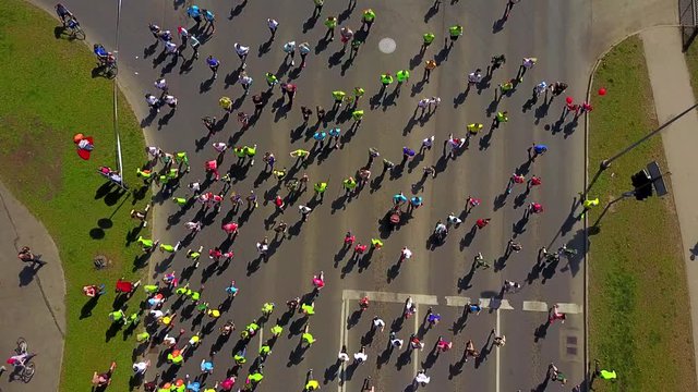 Aerial view of the people running the marathon down the city streets.