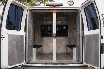 inside a police car. Open doors of a police van. © goodmoments