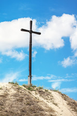 High wooden cross on the hill