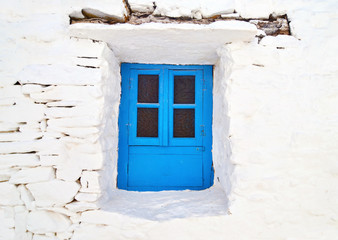 Fototapeta na wymiar Cyclades architecture - traditional blue window at Sifnos island Greece