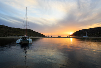 Fabulous Sunset in Kolona double bay, Kythnos, Cyclades, Greece. Sailboats