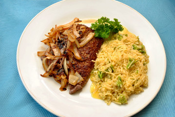 Rice Served with Cube Steaks Smothered with Fried Onions
