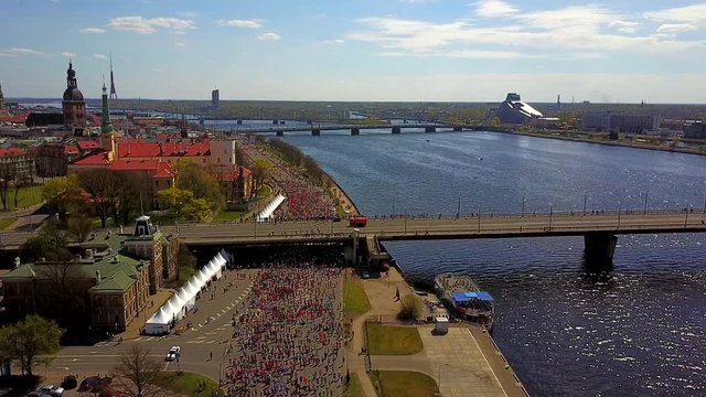 Lattelecom Marathon 2017 in Riga city, Latvia. People running through the streets of Riga down the Krastmala street.