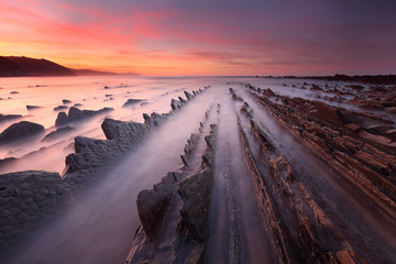 Beautiful sunset over rock formations in Sakoneta beach (Basque country)
