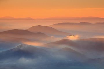 Beautiful sunrise over cloudy mountains