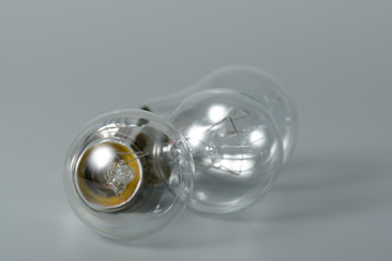 Three incandescent bulbs on grey background