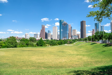 Fototapeta na wymiar Downtown Houston at daytime with cloud blue sky. Green park lawn and modern skylines. It is the most populous city in Texas and the fourth-most in United States. Architecture and travel background.