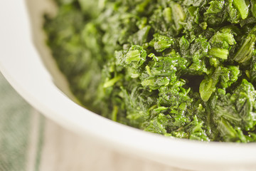 a bowl of cooked spinach