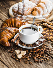 Breakfast with coffee and croissants on table