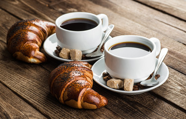 Breakfast with coffee and croissants on table