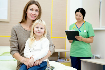 Fototapeta premium Beautiful mature woman and her little daughter at the hospital