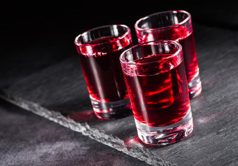 Fresh red juice cocktail with pomegranate seeds and ice