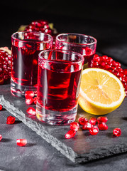 Fresh red juice cocktail with pomegranate seeds and ice