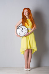woman in yellow dress with clock