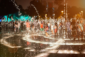 Water fountain splashes at night