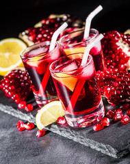 Fresh red juice cocktail with pomegranate seeds and ice