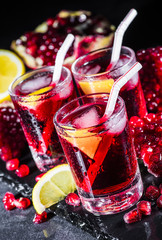 Fresh red juice cocktail with pomegranate seeds and ice