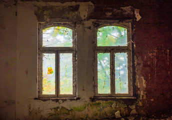 Fototapeta na wymiar The old and ruined widow of building, lost places