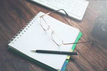 Office table with notepad and keyboard