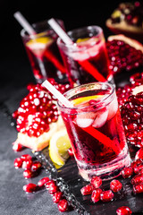 Fresh red juice cocktail with pomegranate seeds and ice