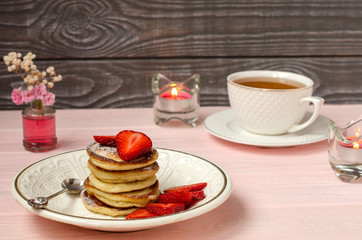 Pancakes with strawberries and tea