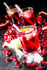 Fresh red juice cocktail with pomegranate seeds and ice