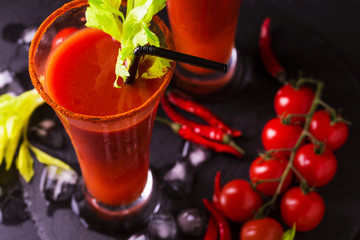 Bloody Mary cocktail with chili pepper, ice and celery.
