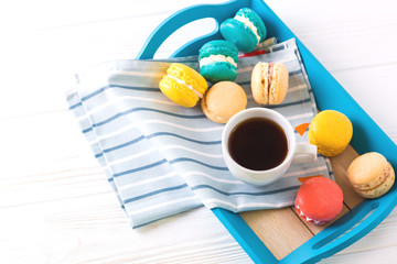 Cup of coffee and macaron cakes on tray