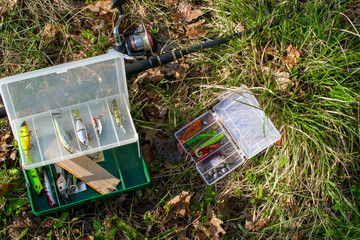 Spinning and set of baits on the grass. Evening fishing.