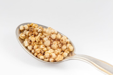 Puffed quinoa seeds (Chenopodium quinoa) isolated on white background