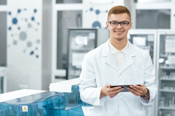 Professional scientist using a digital tablet while working at the lab