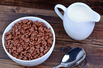 Cereal letters in a ceramic bowl with milk on table