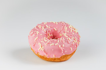 Pink donut on plain background