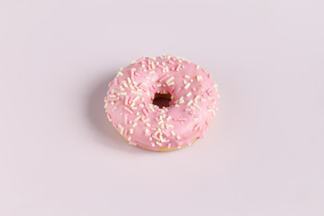 Pink donut on plain background