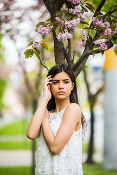 Girl with sakura tree flowers. Spring concept