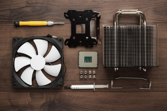 Central Processing Unit And Heat Sink With Cooling Fan On The Wooden Table. Building High-performance Pc Concept