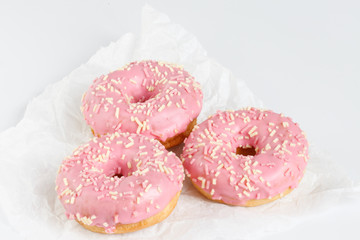 Pink donuts with sprincles on white