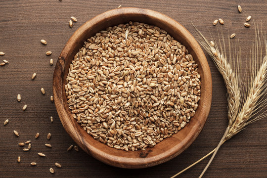 Wheat Seeds For Sprouting In Wooden Bowl On The Brown Table