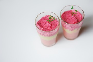 Frozen strawberry smoothie sorbet in glass cups, top view.