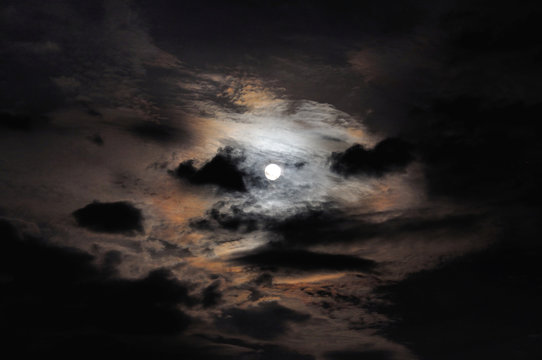 full moon with clouds and colorful Corona (optical phenomenon)